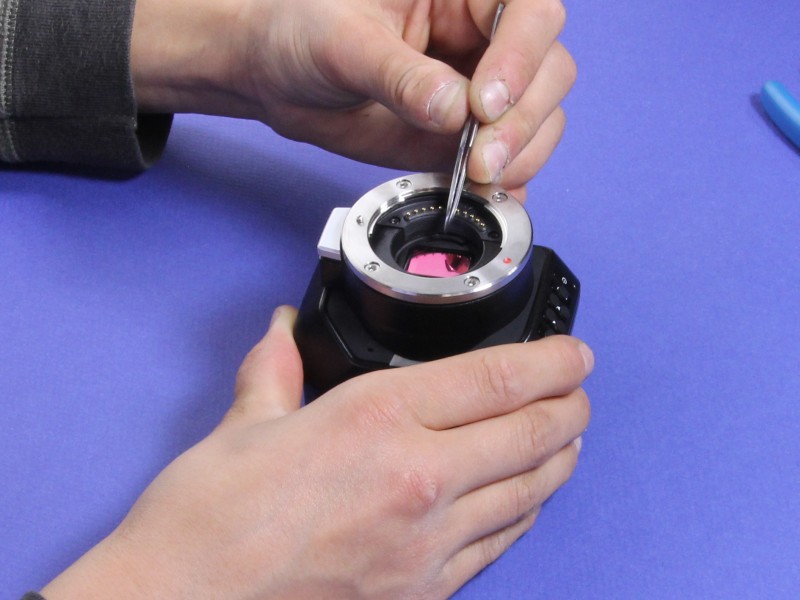 VAF IR optical filter being centered in camera with tweezers